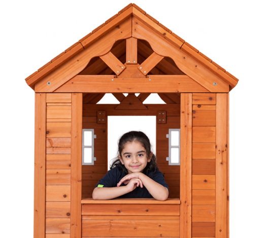 A child peeking out of the wooden playhouse
