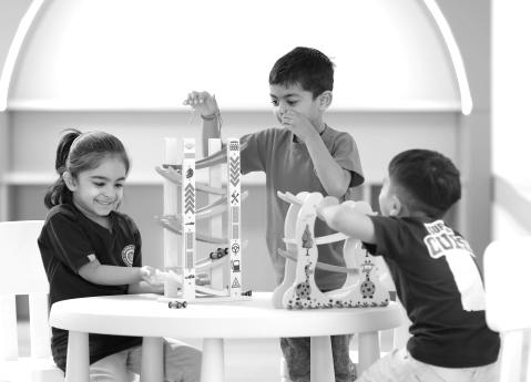 Children building a marble run at a table